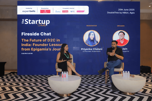 Speakers on stage during a fireside chat